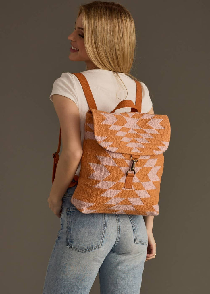 An orange and light pink Aztec backpack